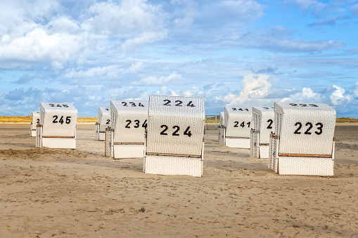 Hooded beach chairs on the beach at the north sea