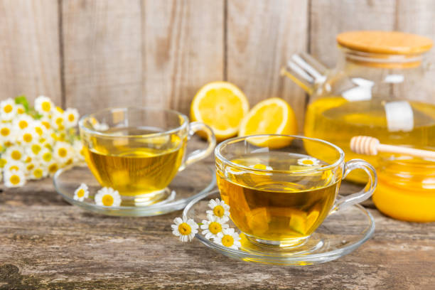 istock Chamomile tea in cup on  texture background. Natural hour with chamomile flowers. Herbal tea. Immunity tea.Natural healer concept. Healthy detox drink.Close up. Place for text. 1690977835