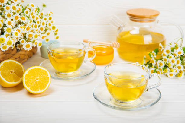 istock Chamomile tea in cup on  texture background. Natural hour with chamomile flowers. Herbal tea. Immunity tea.Natural healer concept. Healthy detox drink.Close up. Place for text. 1690982247