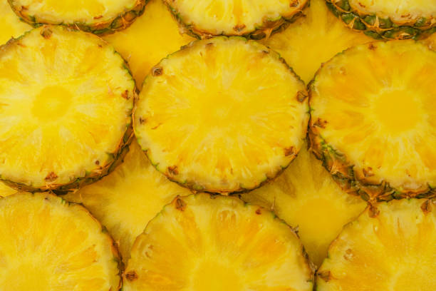 istock Pineapple juicy yellow slices as a background. 1690983998