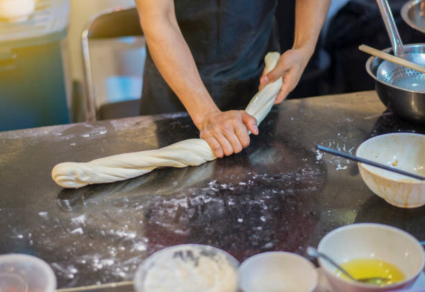 Chef is mixing ingredients and kneading dough for cooking.
