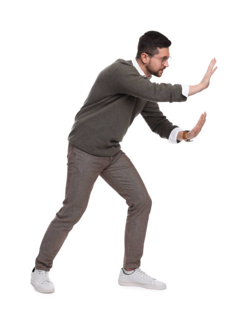 istock Handsome bearded businessman in eyeglasses evading something on white background 1690985786