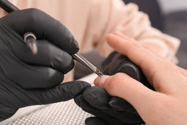 istock Professional manicurist working with client, closeup view 1690992487