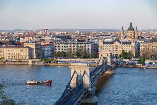 Budapest, Hungary - April 23, 2023: A picture of the St. Stephen's Basilica and the Szechenyi Chain Bridge.