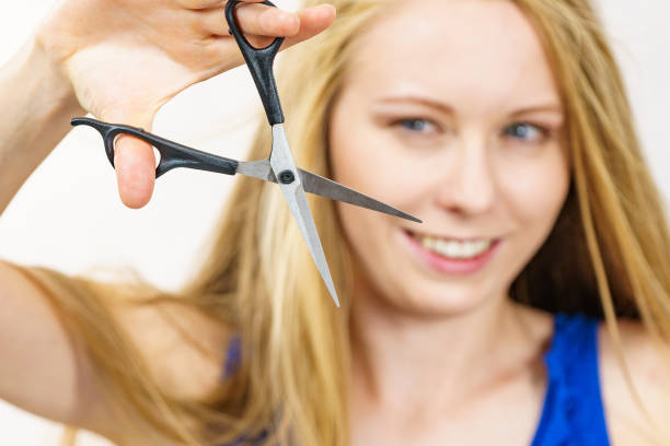 istock Woman with scissors ready to hair cutting 1691005345