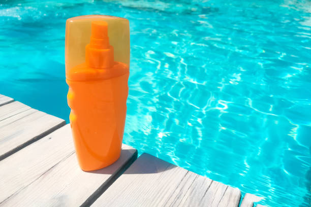 istock Spray sunscreen stands on the background of the pool 1691013111