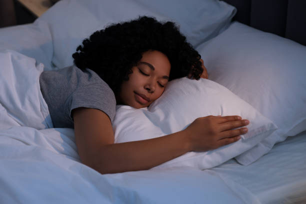 istock Young woman sleeping in soft bed at night 1691017172