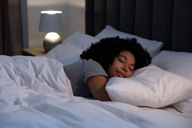 istock Young woman sleeping in soft bed at night 1691017685