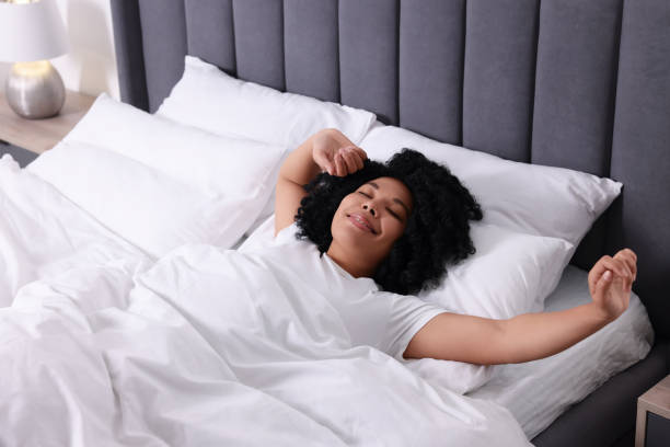 istock Beautiful young woman stretching in soft bed at home 1691017714