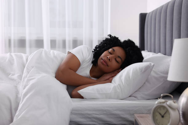 istock Beautiful young woman sleeping in soft bed at home 1691017728