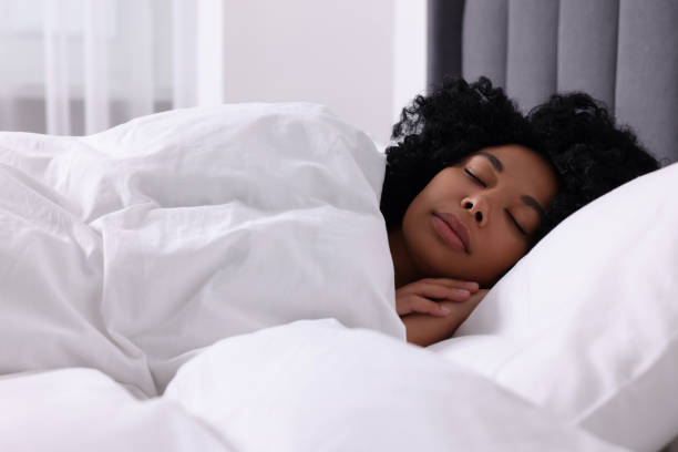istock Beautiful young woman sleeping in soft bed at home 1691018255