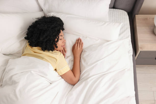 istock Beautiful young woman sleeping in soft bed at home, above view 1691024974