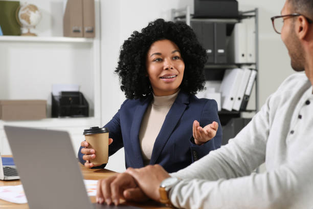 istock Young colleagues working together at table in office 1691034247