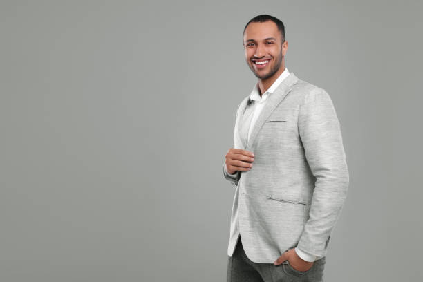 istock Young businessman in formal outfit on grey background. Space for text 1691035458