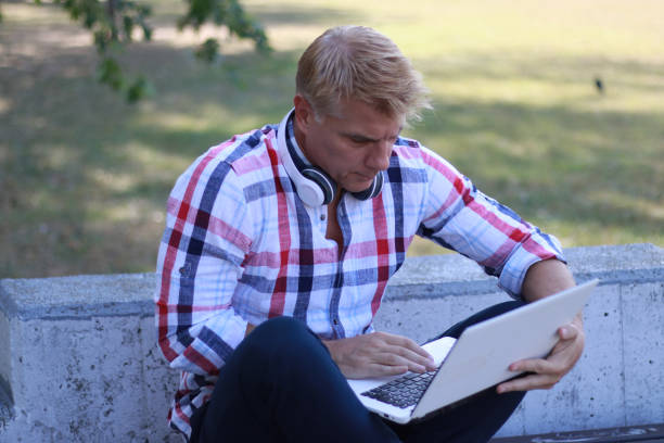 istock Mid aged man working and relaxing in nature 1691057424