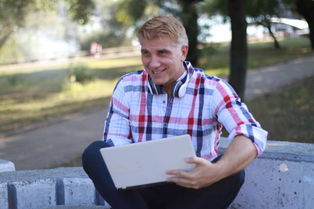 istock Mid aged man working and relaxing in nature 1691057425