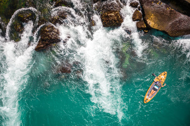 istock Aerial view of Paddleboarding in waterfall 1691059799