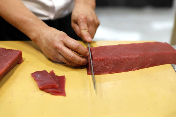 istock cutting tuna with kitchen knife for sushi making 1691060935