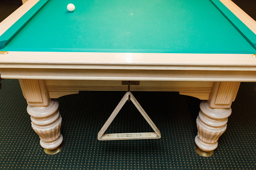 Billiard accessories balls and cue on a billiard table