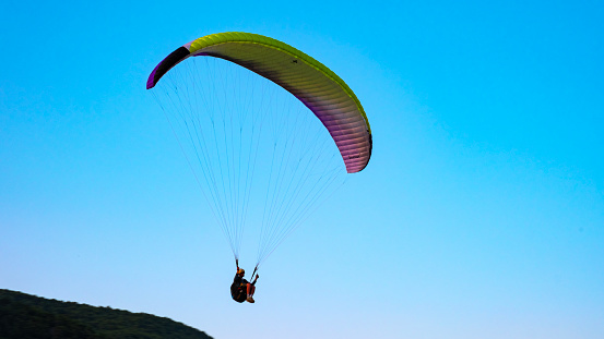 August 8, 2021 - Ager, Spain:  paraglider flying in front of the mountain in Àger, el Montsec, Catalonia, Spain