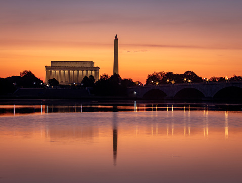 Long Exposure picture of illuminated Washington DC at night with the US. Capitol, Washington Monument and the Lincoln Memorial visible with a waning gibbous moon