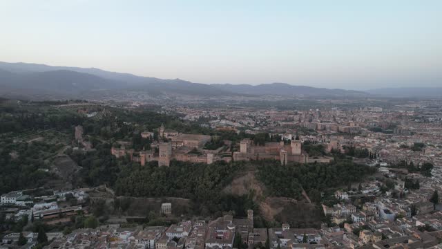 The Alhambra, perched majestically atop a hill in Granada, Spain at sunrise