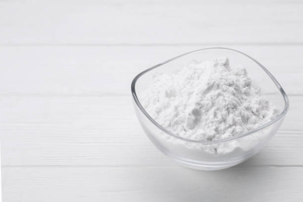 istock Starch in bowl on white wooden table, closeup. Space for text 1691068163