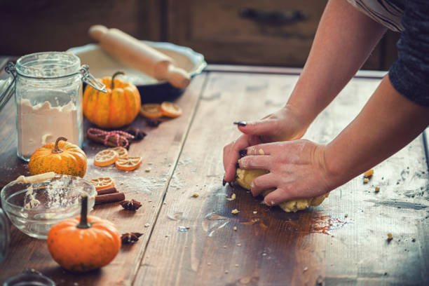 Woman preparing pumpkin pie for the holidays at home stock photo