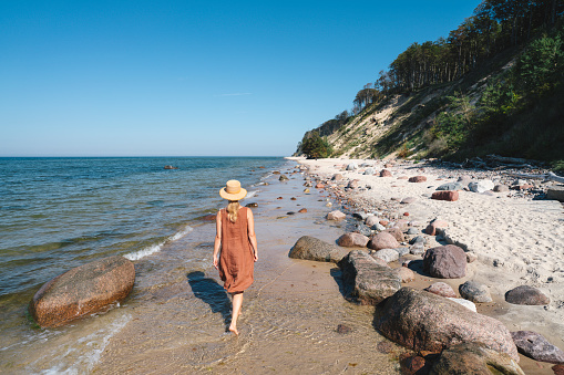 Woman walking on Glazy Piastowskie beach, Poland