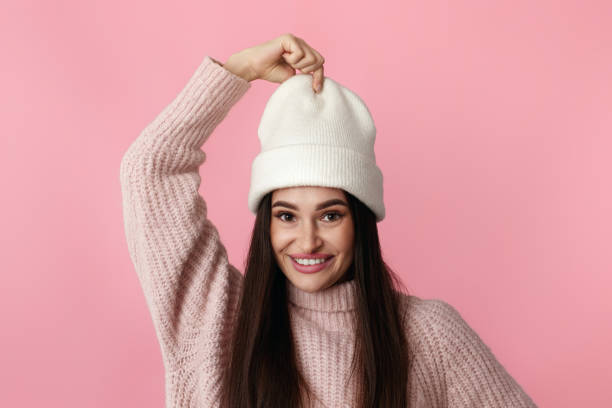istock funny woman in white hat, sweater grimacing with lips 1691132317