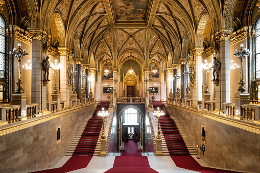 The interior of the Hungarian Parliament Building with the main staircase in Budapest, Hungary on a sunny day.
