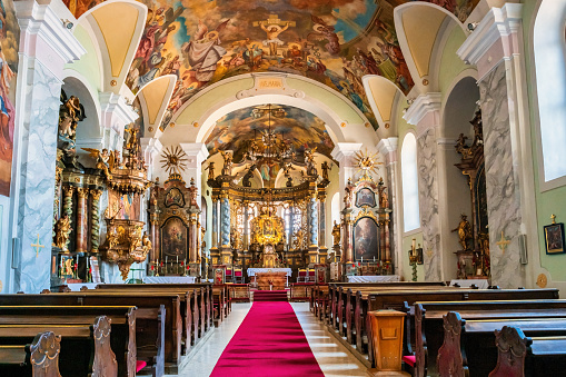 The beautiful interior of the church of Santa Maria della Pace (Church of Saint Mary of Peace) in the historic heart of Rome, in the Piazza Navona district. Built in 1482 during the pontificate of Sisto IV, the church was designed in the Renaissance style with a trapezoidal plan and an octagonal cross by the architect Baccio Pontelli. In 1656 Pietro da Cortona designed the Baroque-style façade with a semi-circular colonnade. Inside the church, rich in numerous chapels, there are architectural and pictorial works by Raphael, Antonio da Sangallo, Rosso Fiorentino, Baldassarre Peruzzi and Orazio Gentileschi. In 1980 the historic center of Rome was declared a World Heritage Site by Unesco. Super wide angle image in 16:9 ratio and high definition quality.