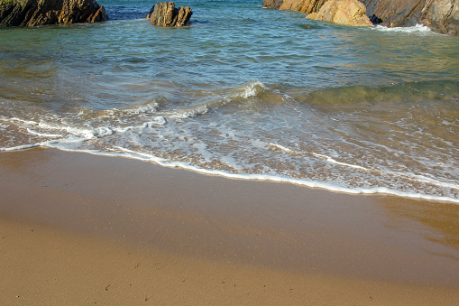 small waves in a beach with rocks in Galicia, Spain