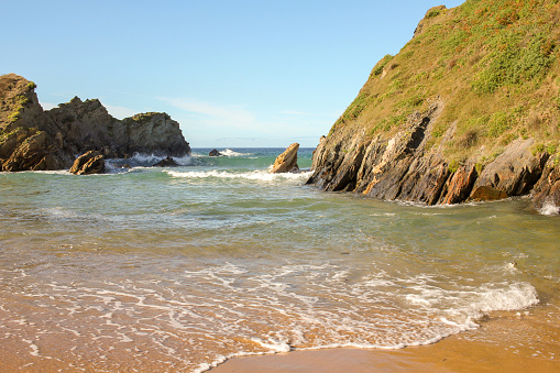 small waves between the rocks in a beach in Galicia, Spain