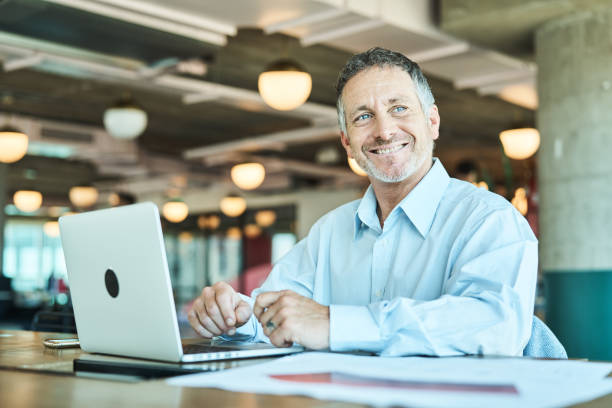 Happy mature businessman at coworking space