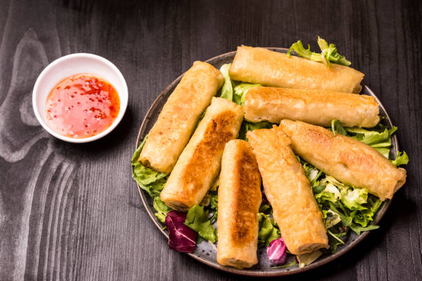 istock Chinese style meal - gyoza dumplings, spring rolls and rice 1691181120