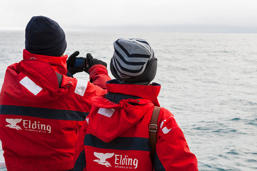 At Sea, Iceland - March 11, 2014. Tourists whale watching in the North Atlantic Ocean off the coast of Iceland.