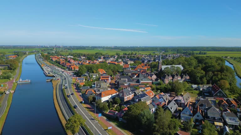 Traditional Noord Holland village next to canal polder in Dutch countryside