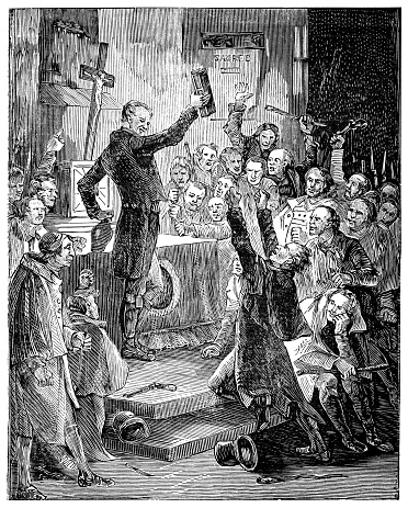 A Catholic priest conducting a secret mass in Ireland circa. 18th century. Vintage etching circa 19th century. Penal laws in Ireland punished Catholics and many priest had to conduct religious masses in secret.