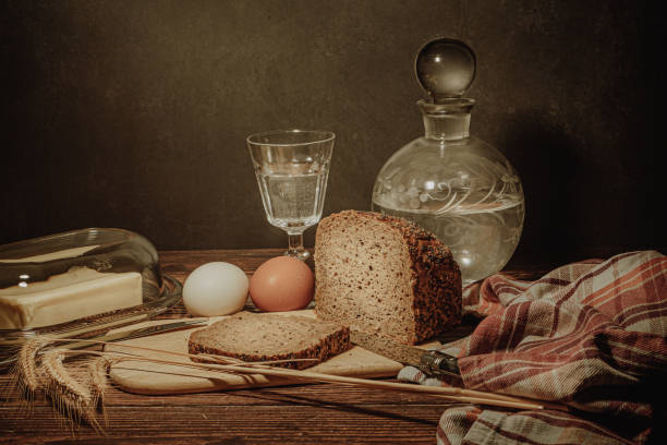 istock Still life with natural products: alcohol, eggs, bread and butter, stylized as antique 1691215622