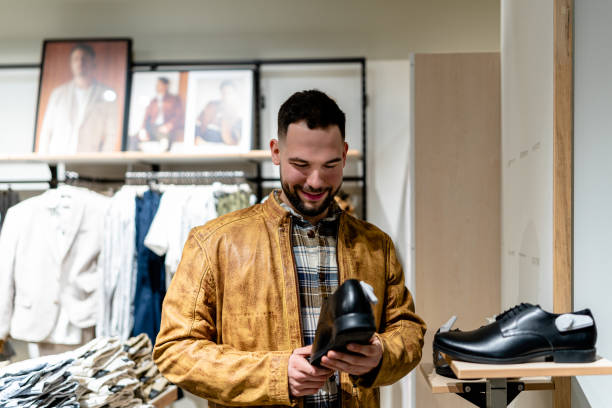 istock Young Man Searches for Clothes in Retail Store 1691218432