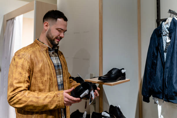 istock Young Man Tries on Clothes at Clothing Store 1691221667