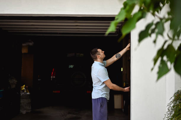 istock millennial man working with a gate in a garage. 1691233177