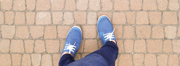 istock Banner with Feet in moccasins on sidewalk. 1691257507