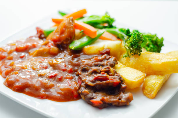 istock Pulled pork in barbecue style sauce with barbecues style beans with spiced chips and fresh vegetables 1691260867