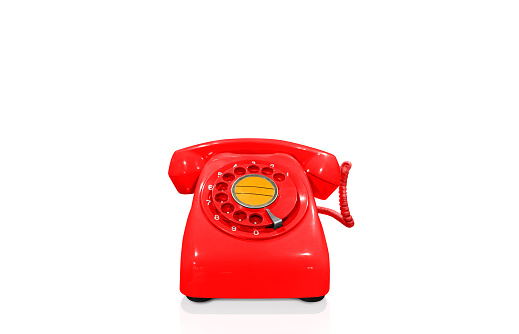 Red vintage telephone isolated on white background