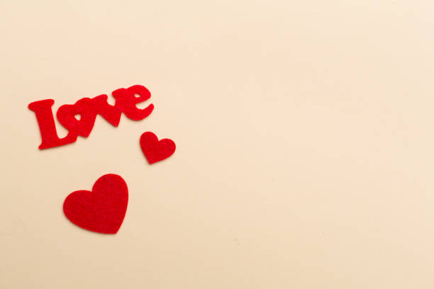 istock Felt word love with hearts on color background, top view 1691277070