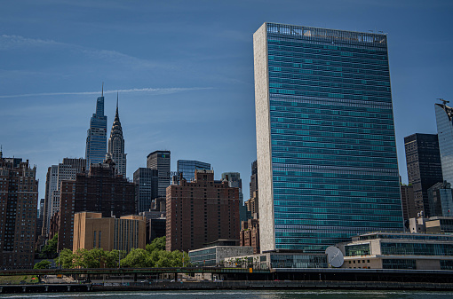 United Nations building in New York City. The skyline of Manhattan in the distance.