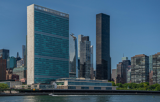 United Nations building in New York City. The skyline of Manhattan in the distance.
