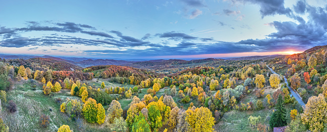 Aerial top view of the autumn forest and hills in Romania. Autumn landscape.